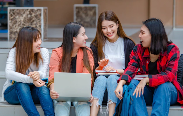 Group Clever Asian Female Students With Laptop Notebooks Sitting University Campus Doing Research Together While Looking Camera Intimate Companion Teens College 102814 3991 - Education Republic